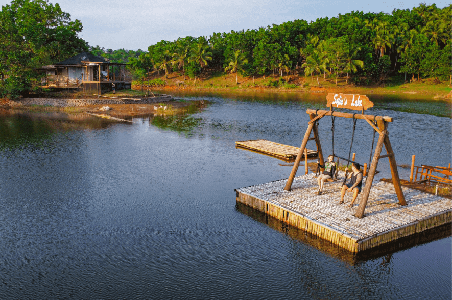 couple on lake swing